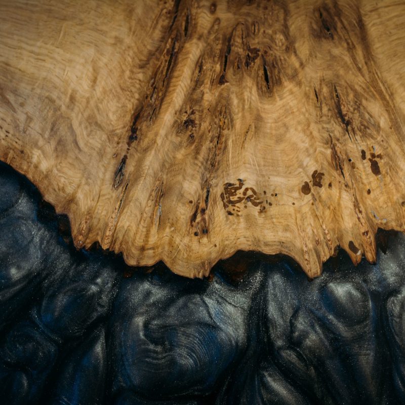 A closeup shot of wood and black background